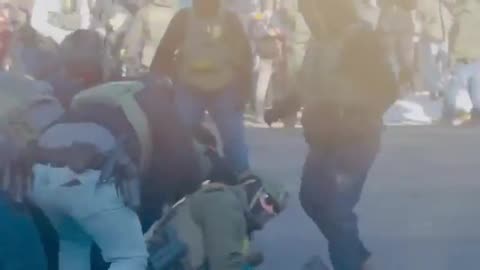 mob beating a federal agent in Minneapolis on the ground