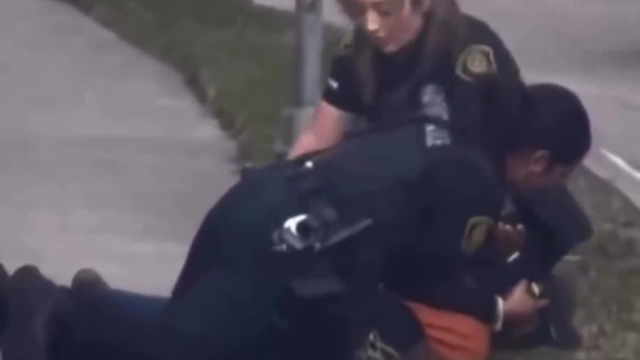 Two Houston female police officers arrest a suspect.