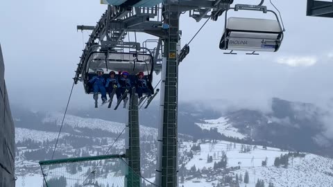 Young Skiers Sing On Chairlift