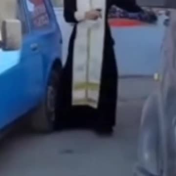 Russian Priest Windexes Holy Water Into Used Vehicles to Protect Russian Soldiers