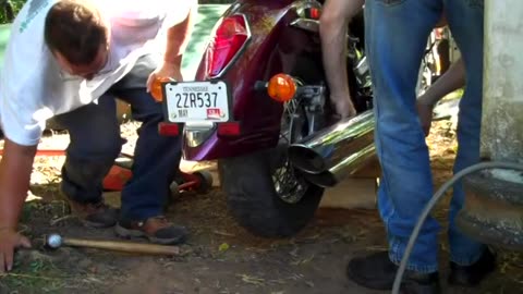 LOL of motorcycle repair lol with random kid jumping in front of camera