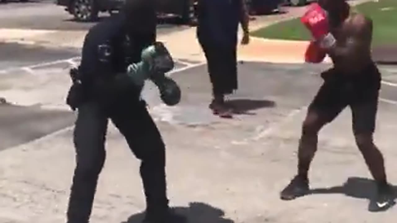 Cop vs man street boxing.