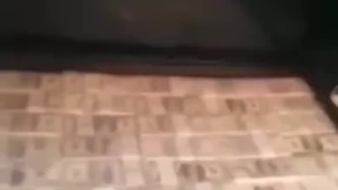 Red Cross with boxes of $100 bills