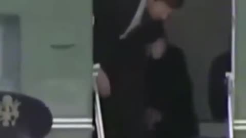 Jr is in the plane facing directly in front of the open door doing the hand signal
			