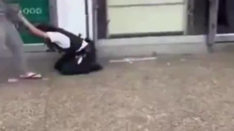 British police fail to arrest an elderly woman who beats them and then runs away.