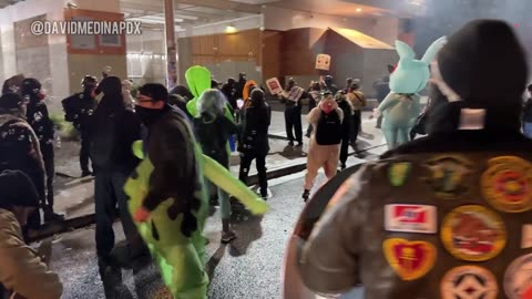 Officers deploy crowd control munitions outside of the Portland ICE facility against