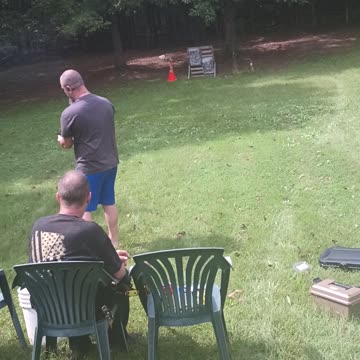My brother with his pistol and target dummy