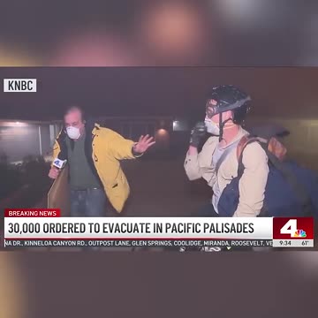 Man Rides Bike Out of Burning Pacific Palisades Neighborhood