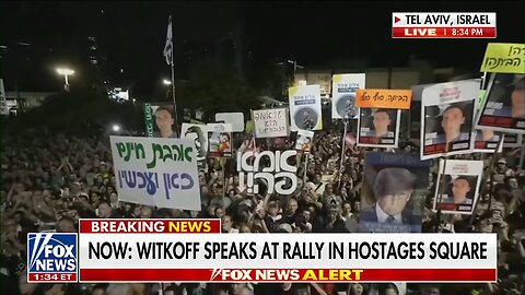 People in Tel Aviv are holding up signs with President Trump's face on them in HOSTAGES SQUARE