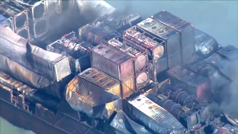 Smoke pours from container ship a day after North Sea collision