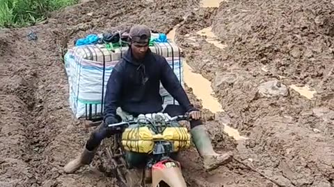 This motorbike continues to accelerate on muddy slopes