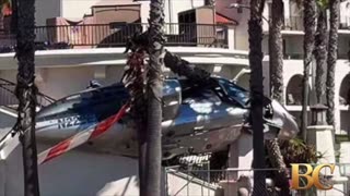 Helicopter spins out of control into palm trees at popular California beach