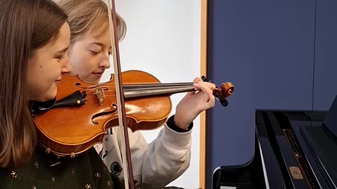 Two Women Simultaneously Playing Two Instruments Together