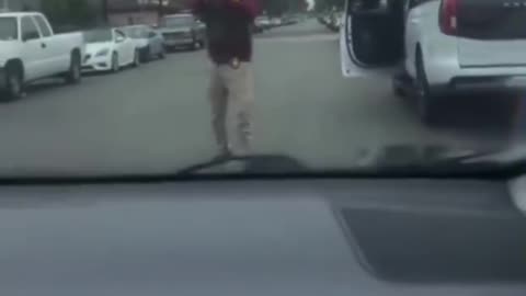 ICE agent pulls a gün on a woman that was following and harassing him.