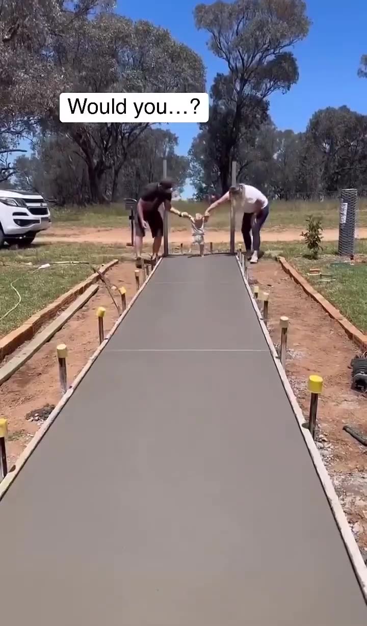 The couple leaving the path to the entrance of their new home with their sons footprints.
