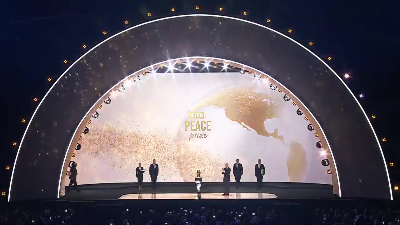 Please welcome the very first winner of the FIFA Peace Prize — the 45th and 47th President