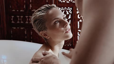 A Couple Kissing at bathtub at shower time