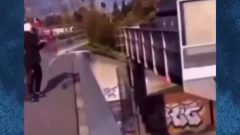 Migrants throw shopping trolley onto busy highway