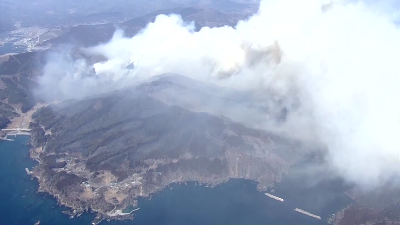 Firefighters struggle to contain a wildfire in northeast Japan