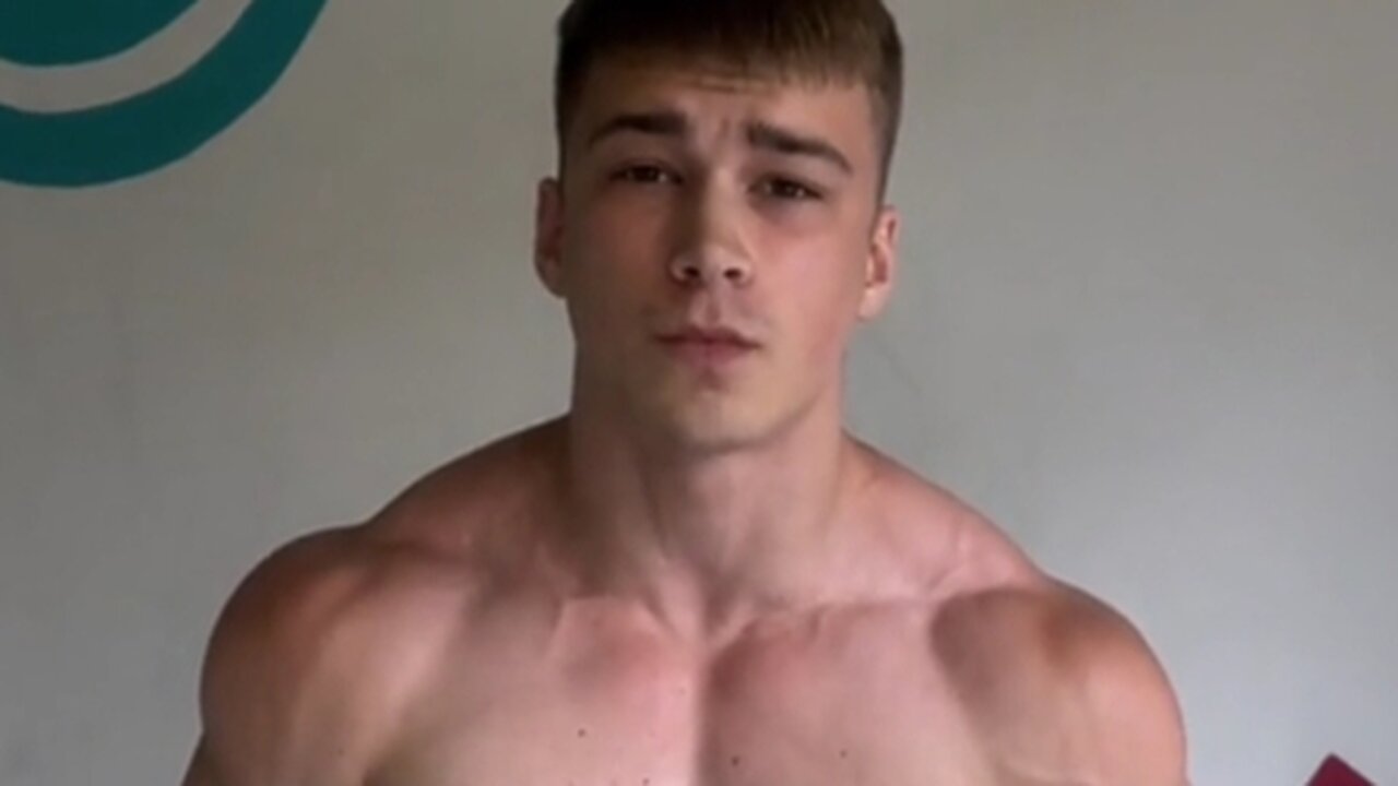 Young man flexing muscles