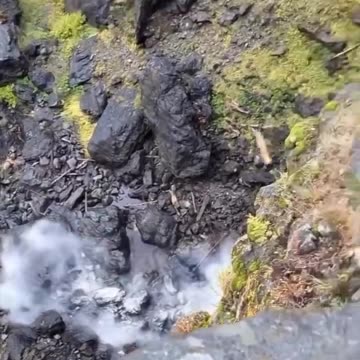 Boulder rolls off cliff, pulverized on landing.