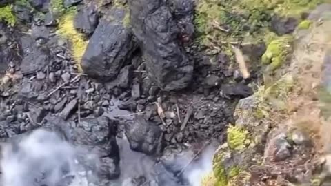 Boulder rolls off cliff, pulverized on landing.