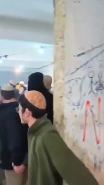 Dozens of settlers are dancing and celebrating in the outpost