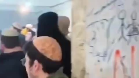 Dozens of settlers are dancing and celebrating in the outpost