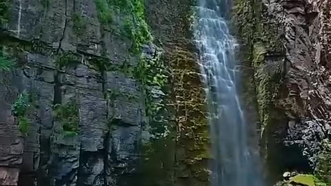 Stunning waterfall amidst majestic mountains ♥️