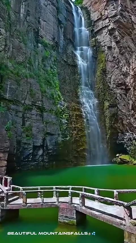 Stunning waterfall amidst majestic mountains ♥️