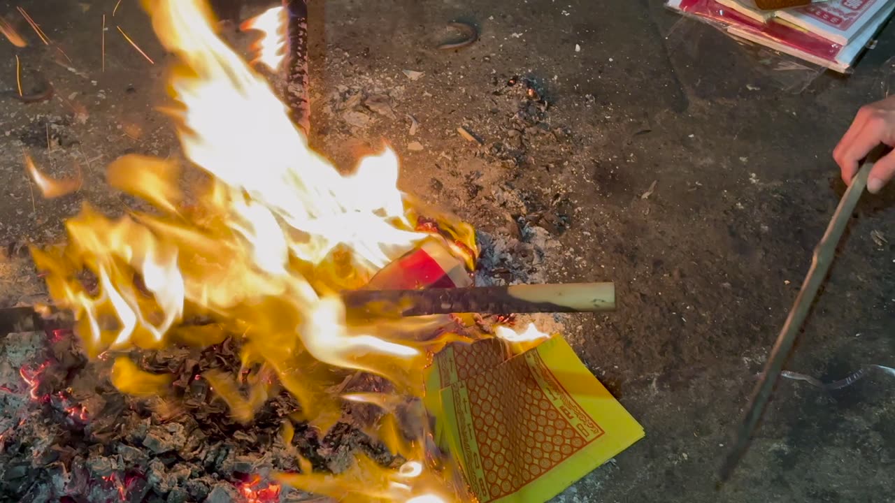 Why do they burn fires in the streets of Hanoi, Vietnam?