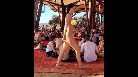 Woman walking naked in a full crowd at festival