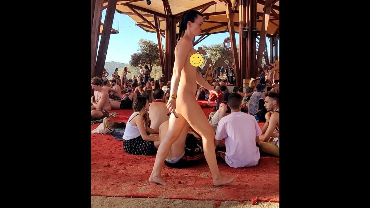 Woman walking naked in a full crowd at festival