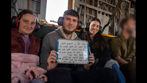 Released hostage Sasha Troufanov writes on a whiteboard during a helicopter