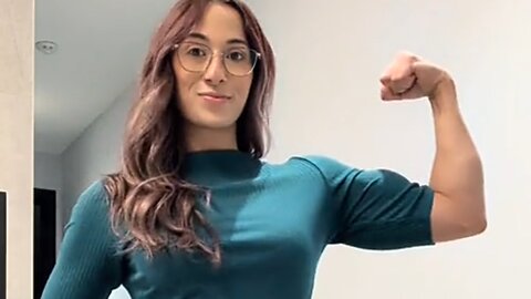 Beautiful mscular woman flexing big biceps