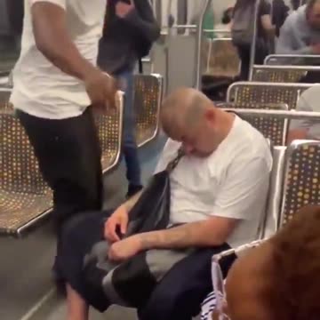 Racist man attacks another man while he is sleeping on the subway