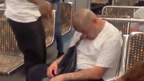 Racist man attacks another man while he is sleeping on the subway