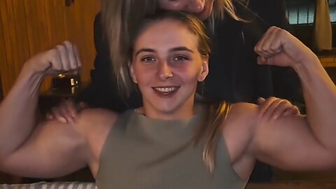 Beautiful muscular woman flexing muscles