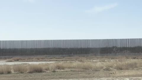 Vance's motorcade passes the border wall