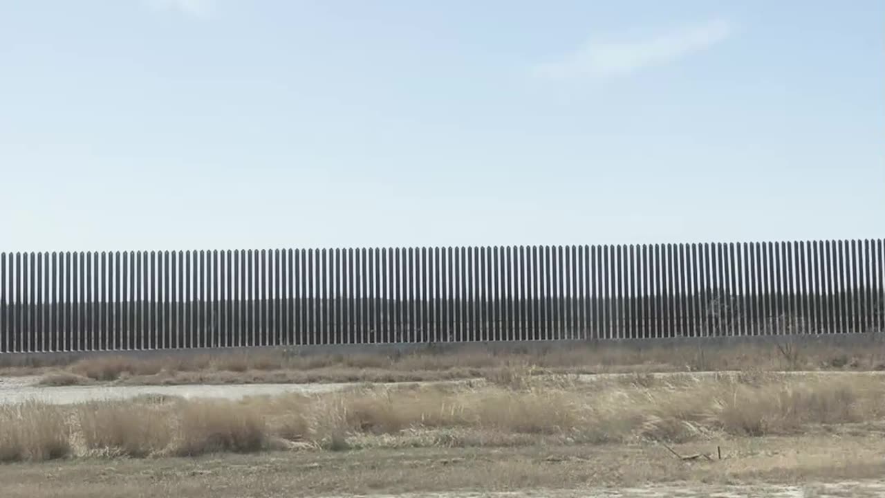 Vance's motorcade passes the border wall