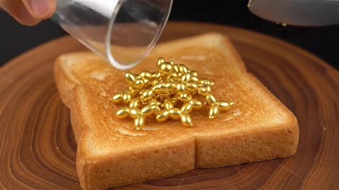Spreading golden objects on toast #asmr #whichonewouldyoupick #asmrsounds #oddlysatisfying