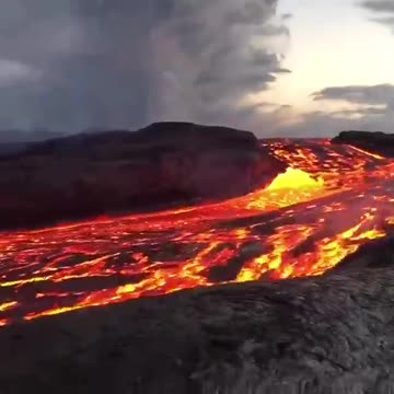 Incredible close up footage of a fast flowing river of lava rushing from Hawaii's Kilauea volcano.