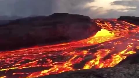 Incredible close up footage of a fast flowing river of lava rushing from Hawaii's Kilauea volcano.