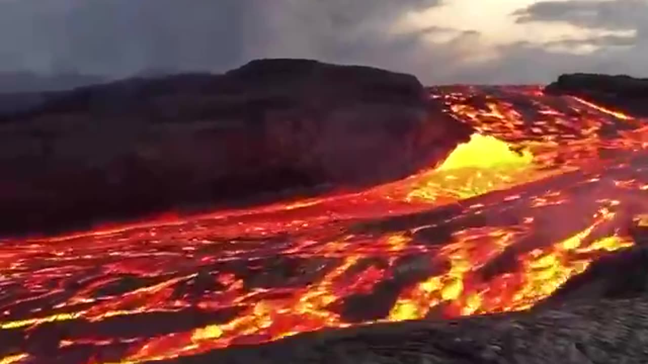Incredible close up footage of a fast flowing river of lava rushing from Hawaii's Kilauea volcano.