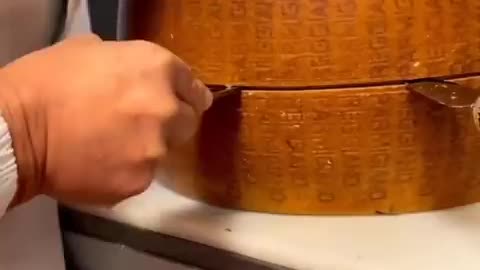 The opening of a wheel of Parmigiano Reggiano after 10 years