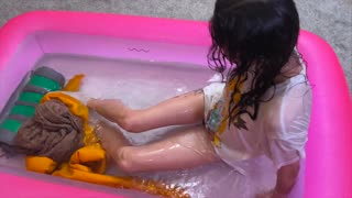 she got all wet in her home clothes in a pool of water