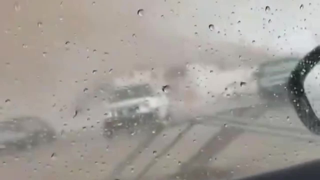 Tornado tears through parking lot, partially damages building in Gautier, Mississippi.