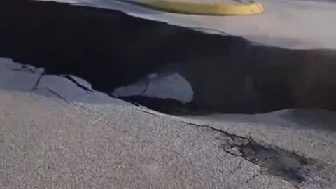 🔥🔥🔥 A massive sinkhole, has suddenly appeared on a road. Location in Europe yet to be confirmed.
