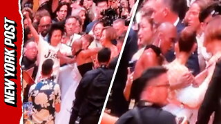 Cynthia Erivo rushes to protect Ariana Grande from a charging fan on the red carpet in Singapore