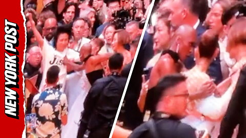 Cynthia Erivo rushes to protect Ariana Grande from a charging fan on the red carpet in Singapore